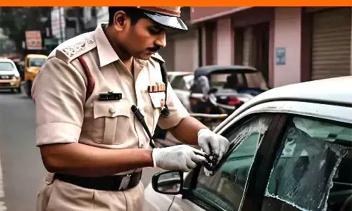 Indian traffic police in white uniform removing black film from car windows